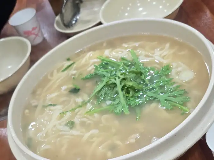넓은 그릇에 담긴 김치와 칼국수