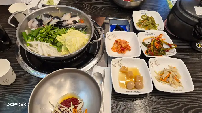 복전골 냄비와 함께 여러 가지 소담한 반찬들이 가지런히 놓여 있습니다.
