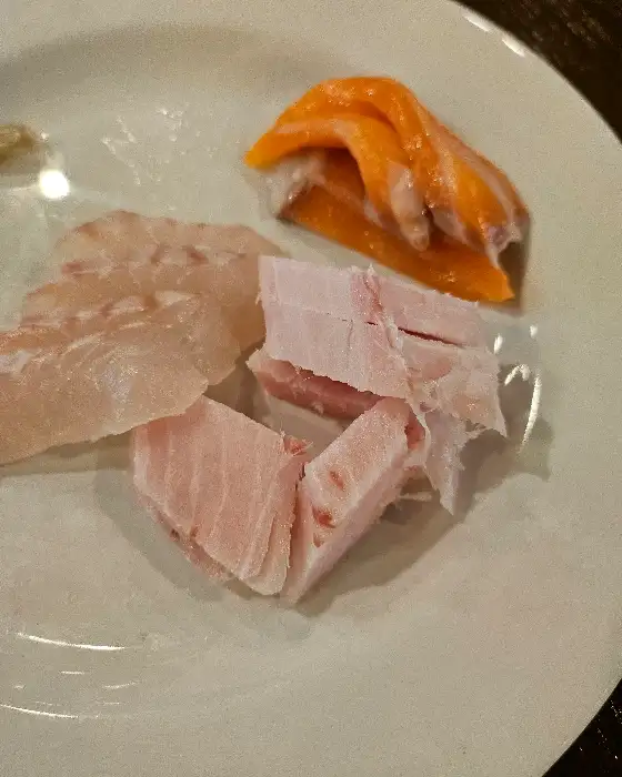 구운 연어와 광어회 조각이 접시에 담겨 있다.