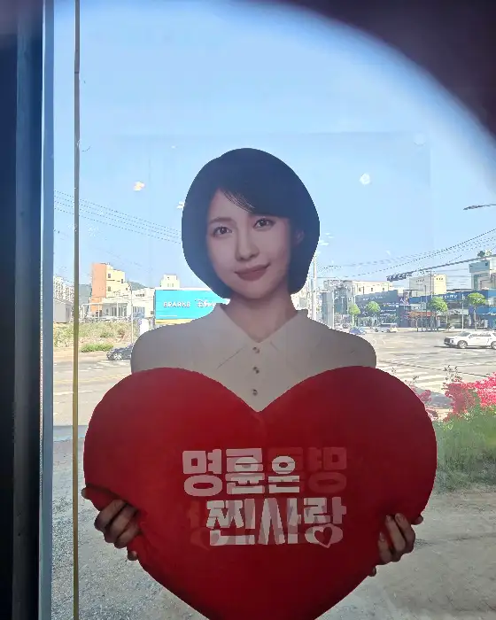 하트를 들고 있는 밝게 웃는 여성 모델
