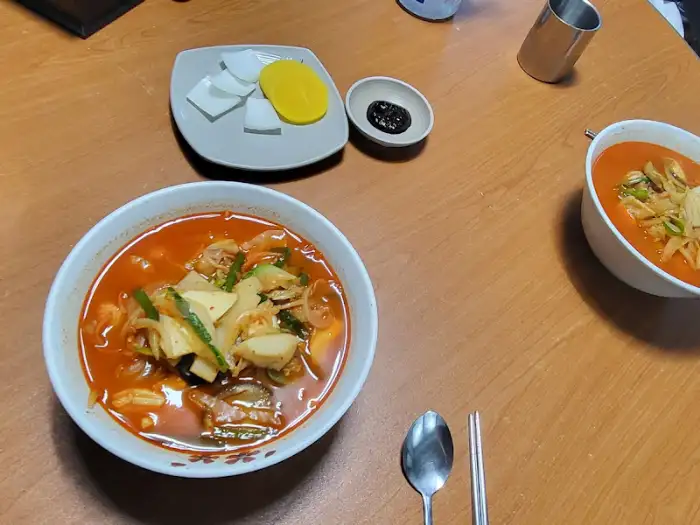 테이블에 놓인 짜장면과 짬뽕, 그리고 기본 찬