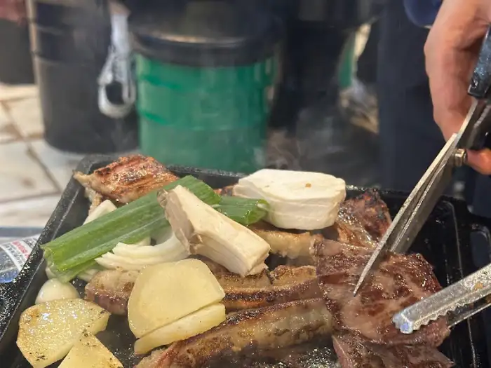 신선한 곱창과 대창, 다양한 채소가 불판 위에 올라간 모습