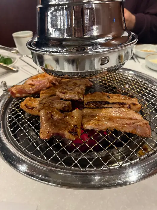 집게로 고기를 뒤집고 있는 모습