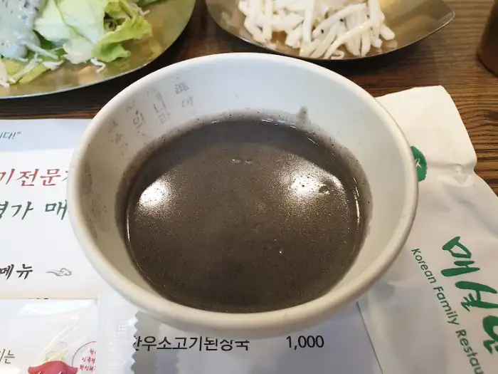 검은색 깨 소스 같은 것이 담긴 그릇