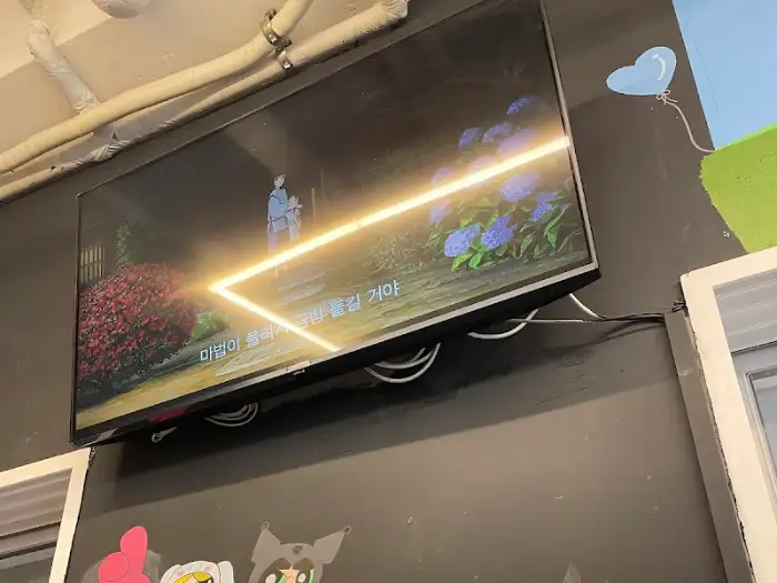 테이블에 놓인 TV에서 일본 애니메이션이 상영되고 있는 모습