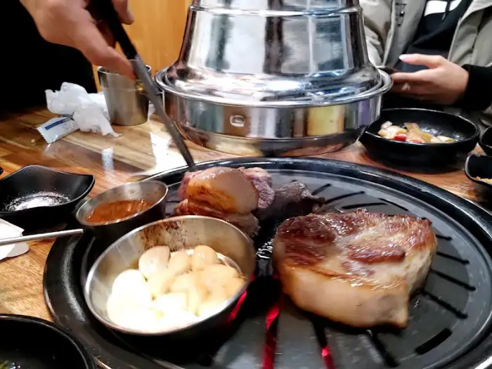 두툼한 삼겹살이 불판 위에서 익어가는 모습