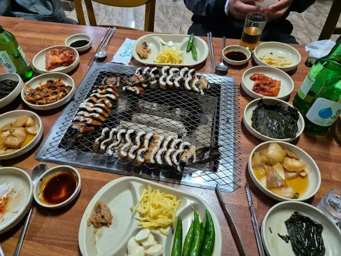 테이블 위 장어구이와 반찬들