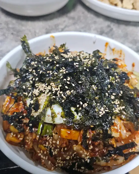 김이 모락모락 나는 중화비빔밥에 김가루와 깨가 듬뿍 뿌려진 모습