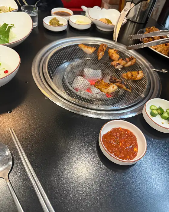 잘 익어가는 숯불 닭갈비와 곁들임 반찬 모습