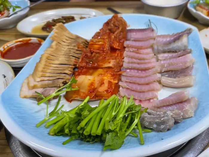 홍어, 돼지고기, 김치, 미나리가 담긴 삼합 접시