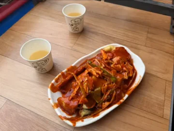 영주랜떡 떡볶이와 음료가 담긴 흰색 접시